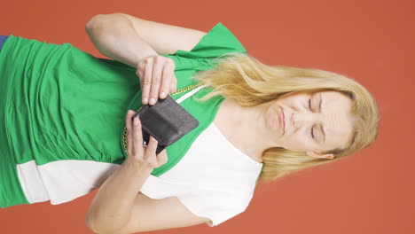 Vertical-video-of-Penniless-woman-looking-at-her-empty-wallet.